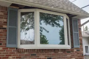A picture of a bay window featuring vinyp replacement windos