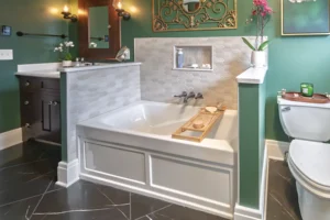 Custom bathroom remodel in West Seneca featuring a drop-in soaking tub with a decorative tile surround and integrated fixtures by Kaz Home Improvements