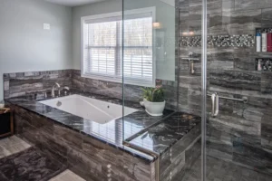 Bathroom remodel, featuring an ultra-modern bathtub and shower configuration. A full glass shower stall with tile and marble.