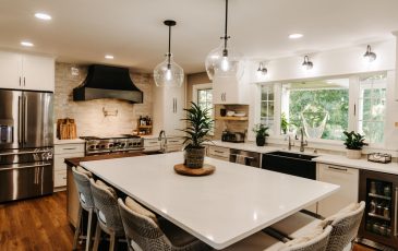 A beautiful kitchen layout with a large center island and granite counter tops