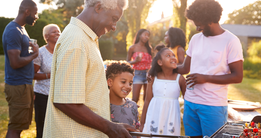 A multi-generational family enjoying themselves at a backyard BBQ