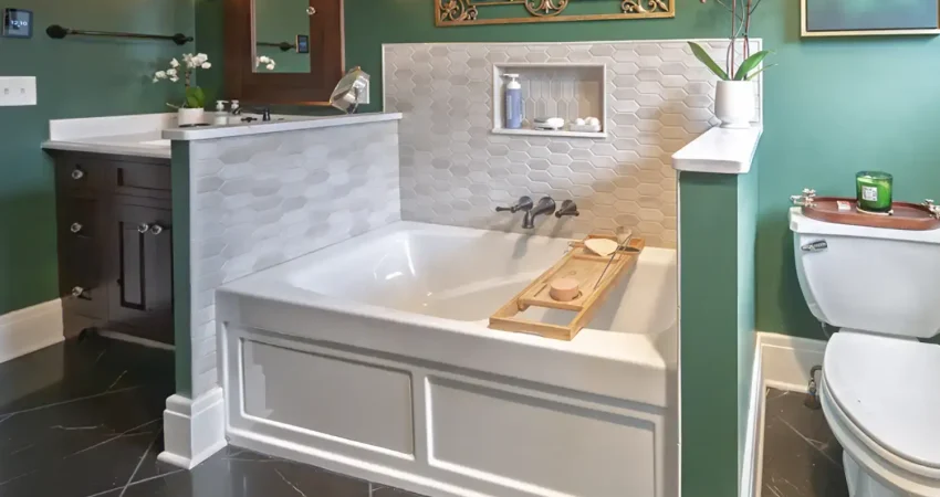 Custom bathroom remodel in West Seneca featuring a drop-in soaking tub with a decorative tile surround and integrated fixtures by Kaz Home Improvements