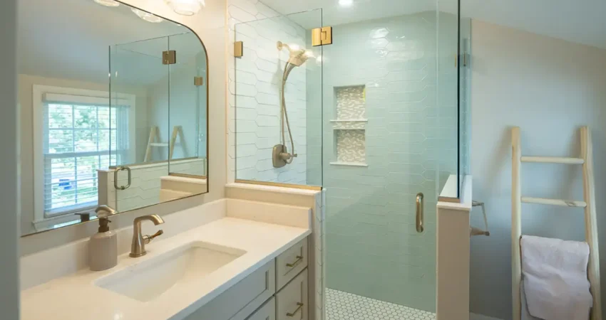 Bathroom remodel by Kaz Home Improvements in Buffalo NY with glass shower stall, white countertop, and gray shaker cabinets