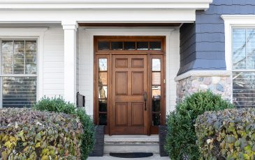 A wooden front door, surrounded by windows, with white, blue, A wooden front door, surrounded by windows, with white, blue