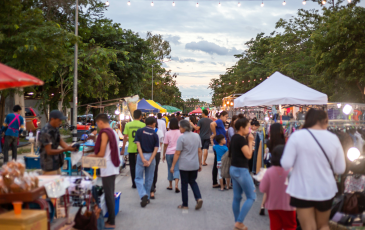 Various people wandering through an open-air festival or market