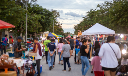 Various people wandering through an open-air festival or market