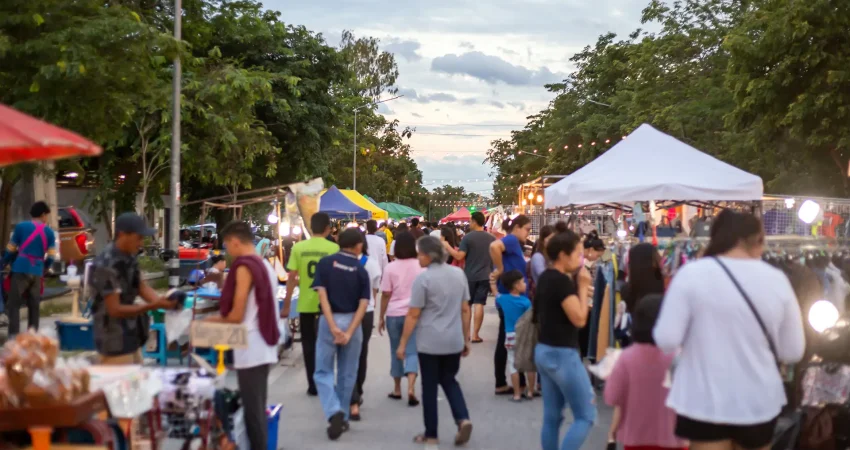 Various people wandering through an open-air festival or market