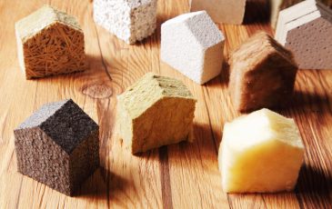 Close up Various Scattered Blocks of insulation Model Hous in Different Standing on Top of the Wooden Table
