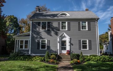 A picture of an early traditional style house with replacement windows