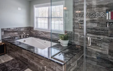 Bathroom remodel, featuring an ultra-modern bathtub and shower configuration. A full glass shower stall with tile and marble.