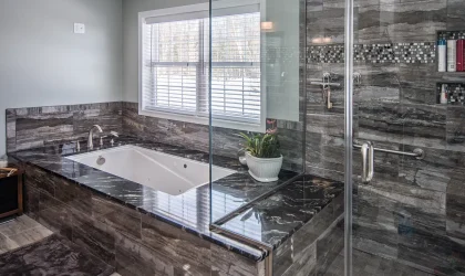 Bathroom remodel, featuring an ultra-modern bathtub and shower configuration. A full glass shower stall with tile and marble.