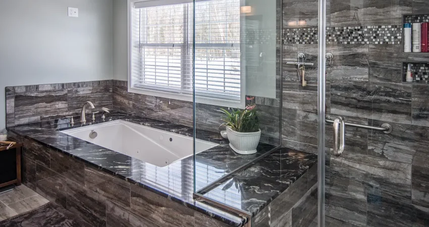 Bathroom remodel, featuring an ultra-modern bathtub and shower configuration. A full glass shower stall with tile and marble.