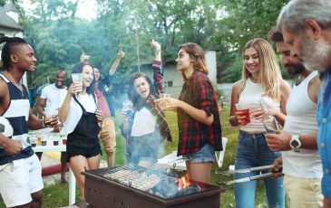 A group of people having a good time at a backyard BBQ