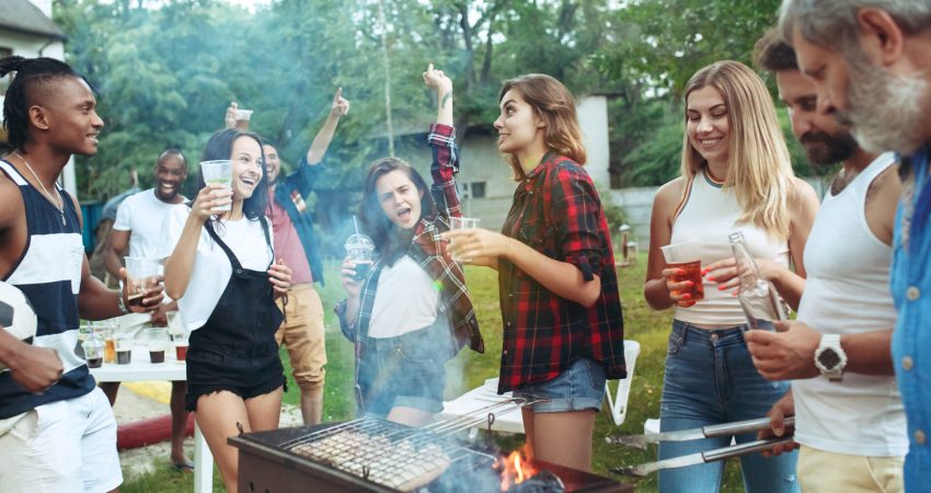 A group of people having a good time at a backyard BBQ