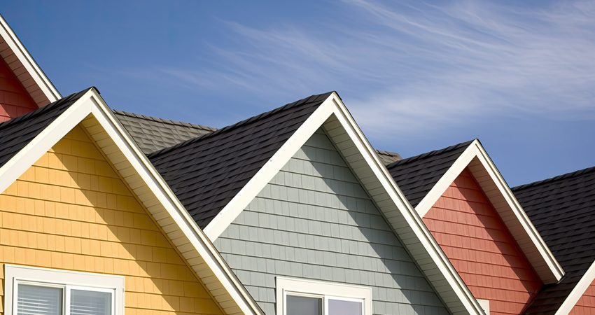 Jerkinhead roofs blending gable and hip roof features solid color background