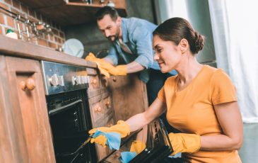 A picture of a coupl ecleaning their kitchen