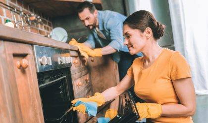 A picture of a coupl ecleaning their kitchen