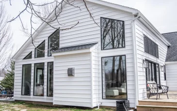 Exterior view of a home addition with large custom windows