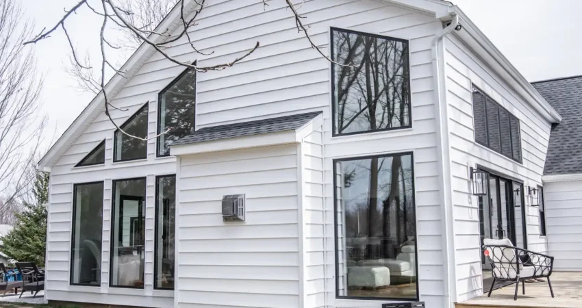Exterior view of a home addition with large custom windows