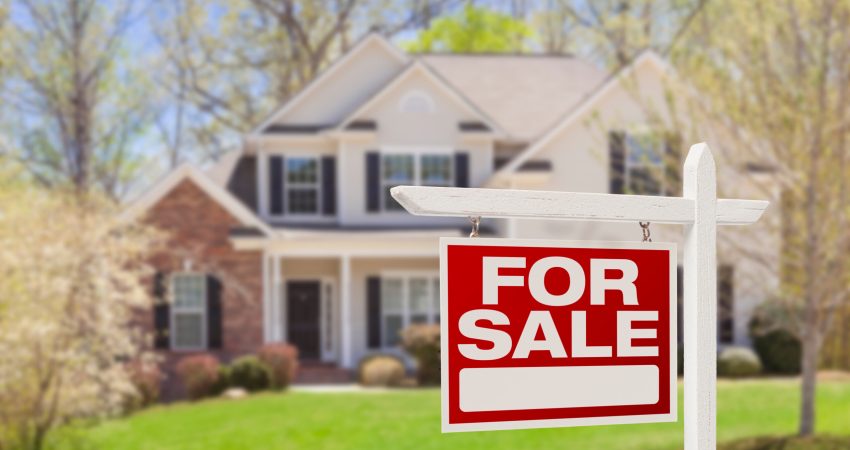 Home For Sale Real Estate Sign and Beautiful New House.