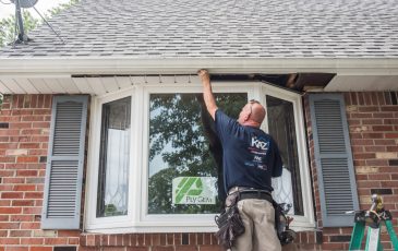 A Kaz exterior craftsman installing vinyl siding and windows at a home
